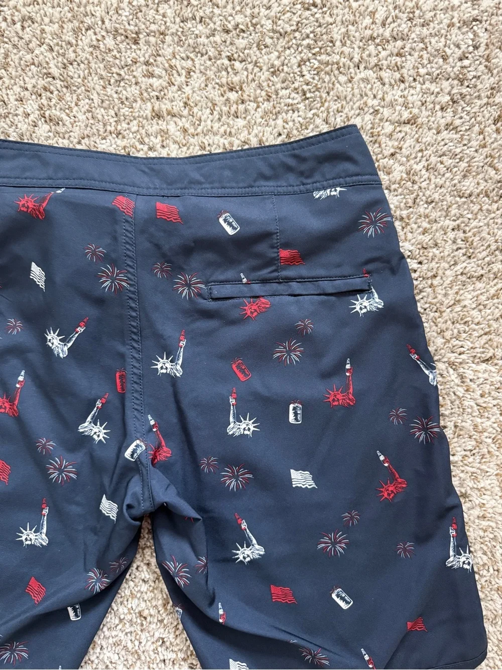 Travis Mathew Navy Swim Shorts with Red & White Liberty Icons